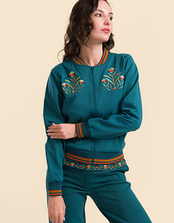 Model draagt Lalamour Nora bomberjack petrol met geborduurde bloemen op de borst