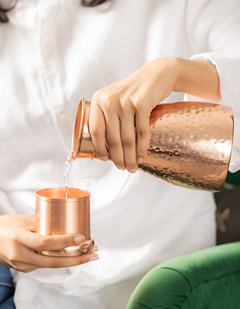 koperen waterkan met beker