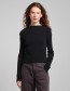 Zwarte rib top van Dedicated met mock neck en babylock afwerking.